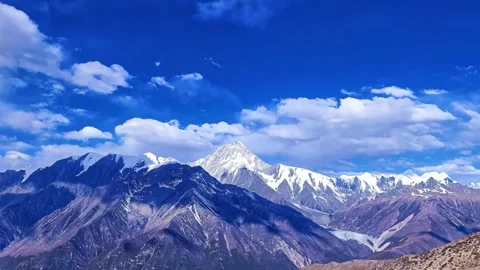 Majestic Snow Capped Mountain Range Under Vibrant Blue Sky China Stock Footage 346737617