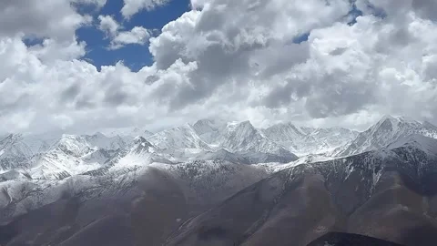 Majestic snow capped mountains with dramatic clouds time lapse Tibet Видео 333776850