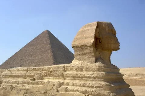 Majestic Sphinx and the Great Pyramids of Giza Under a Clear Blue Sky in Egyp Stock Photos