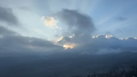 Majestic sun rays breaking through clouds over misty mountains. Stock Footage 328779583
