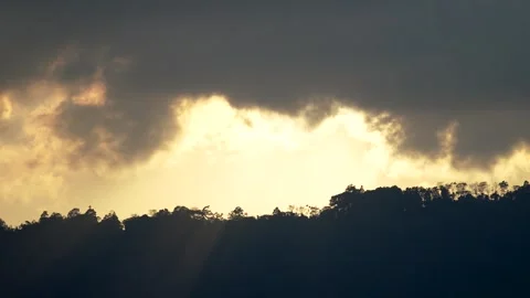 Majestic Sunset Over Mountain Range, Cloudy Sky Emitting Golden Rays Stock Footage 264348049