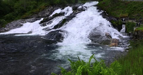 Majestic waterfall cascades down in Hellesyit Stock Footage 312314765