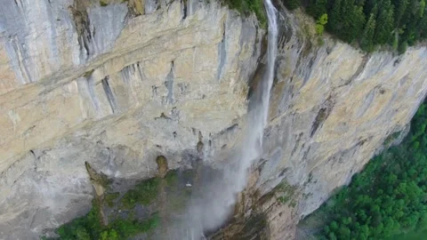 Majestic waterfall cascading down steep cliffs in Switzerland Video stock 320265035