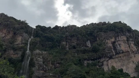 Majestic waterfall cascading down a steep rocky cliff Stock Footage 330195184