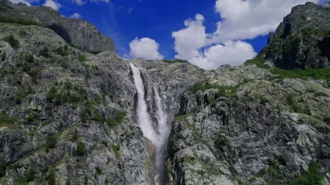 Majestic Waterfall Splendor under Cloud Adorned Skies Stock Footage 256179968