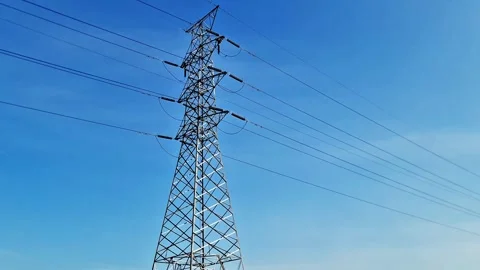 Majical High Voltage Lattice Tower Standing Over Lush Green Rice Field in Rural Stock-Footage 332893361