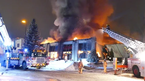 Major fire has completely destroyed large surface building sending smoke up Stock-Footage 115011218
