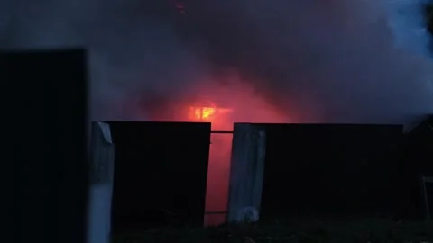 Major House Fire Spreads Quickly at Night, Causing Heavy Smoke and Flames in Stock Footage 321935574
