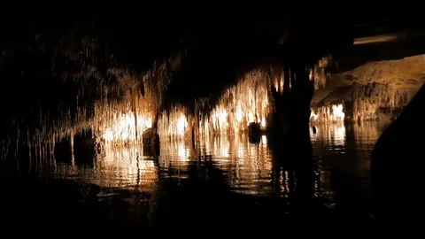 MAJORCA, SPAIN Tourists float on a boat on the underground lake in the famous Stock Footage 86156703