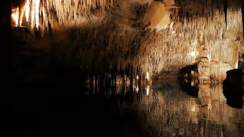 MAJORCA, SPAIN Tourists float on a boat on the underground lake in the famous Stock Footage 86157376