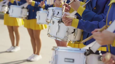 Majorets are lined and knocking out the melody. Street performance on the drums Stock Footage 242428730