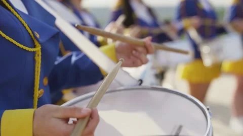 Majorets are lined and knocking out the melody. Street performance on the drums Stock Footage 242428899