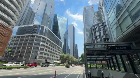 Makati CBD central business district street traffic and high rise skyline 4K 스톡 동영상 337448892