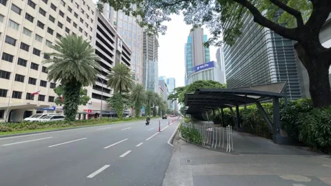 Makati CBD elevated pedestrian walkway infrastructure and lush greenery 4K Stock Footage 337448980