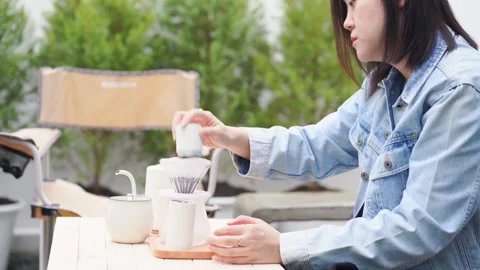 Make and drink coffee at home and play with her cat Stock Footage 270454967