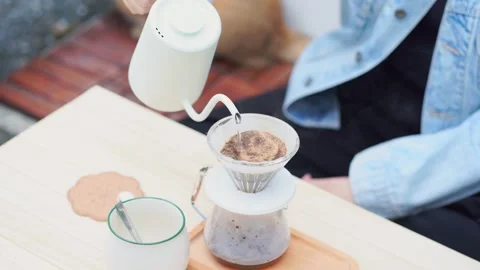 Make and drink coffee at home and play with her cat Stock Footage 270455006