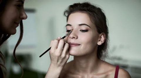 Make-up artist and model. Beautiful girl laughing and smiling Stock Footage 66824803