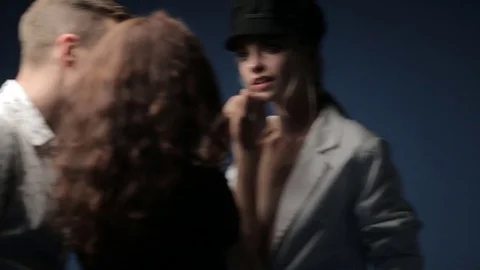 A make-up artist and a stylist work with a model in a black hat Video stock 81064361