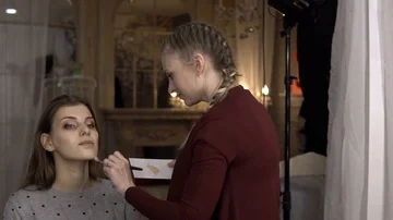 Make-up artist applies blush on model Vídeo Stock 85756714