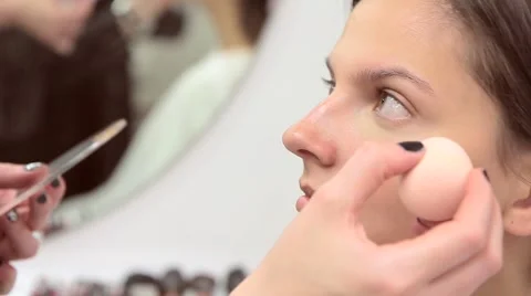 Make-up artist applies concealer on the model's face Stock Footage 68715219