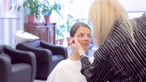 Make-up artist applies eye shadow with a brush Video stock 68716649
