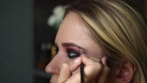 Make-up artist applies makeup to the brows, master class of professional Stock Footage 212136679