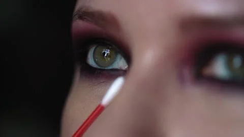 Make-up artist applies makeup to the lower eyelid, cotton swab Stock Footage 211736490
