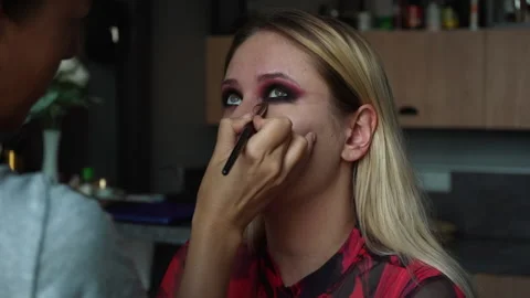 Make-up artist applies makeup to the lower eyelid, master class of professional Stock Footage 211736603