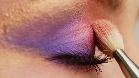 Make-up artist applies makeup to the upper eyelid, close-up.  Tutorial master Stock Footage 194962224