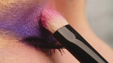 Make-up artist applies makeup to the upper eyelid, close-up.  Makeup artist a Stock Footage 201354032