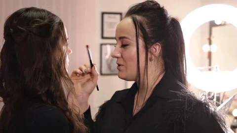 Make-up artist applies shadows with a professional brush Stock Footage 84989014