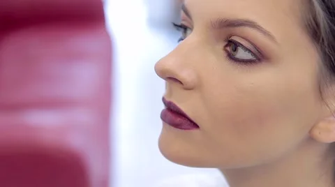 Make-up artist applying bright lipstick to model's lips Stock Footage 68749449