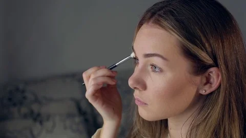 Make-up artist applying eye shadow with brush, close up Stock Footage 75457908