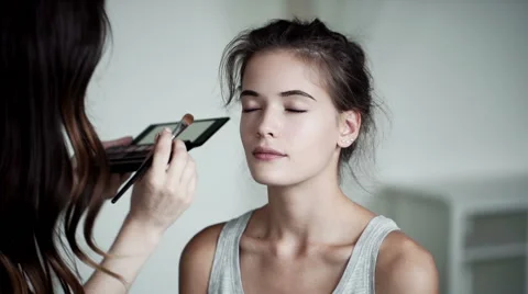 Make-up artist applying eyelash makeup to model's eye. Close up view. Stock Footage 66823187