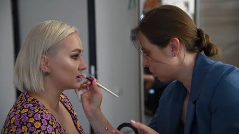 Make-up artist applying lipstick Stock Footage 255402483