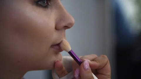 Make-up artist applying lipstick Stock Footage 255402485