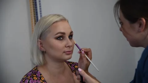 Make-up artist applying make-up foundation Stock Footage 255402456