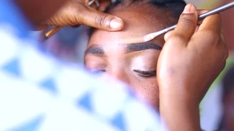 Make up artist applying makeup foundation on eye shadows Stock Footage 204950581