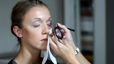 Make up artist applying makeup to model Stock Footage 122901758