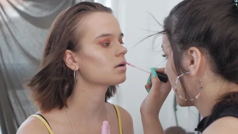 Make-up artist applying makeup to model's face Close up view. Stock Footage 138127868