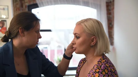 Make-up artist applying mascara applicator on eyebrows Stock Footage 255402450