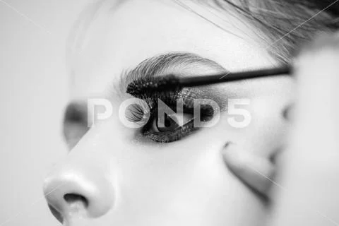 Make-up artist applying the mascara to model. Sexy Lady, Fashion, Beauty. Stock Photos