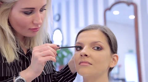 Make-up artist applying the mascara to model's eyes Stock Footage 68746122
