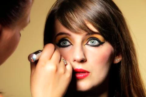 Make up artist applying oriental eastern makeup Stock Photos