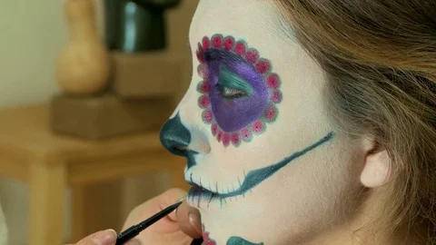 Make-up artist applying sugar skull mexican make up Stock Footage 82720444