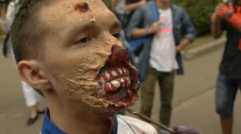 Make-up artist with a brush transforms man into a zombie, make-up for zombies Stock Footage 68209389