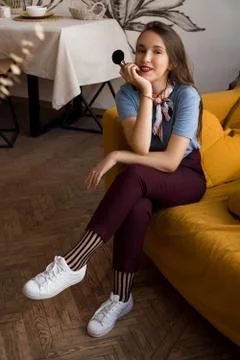 Make-up artist with brushes sitting on the couch Stock Photos