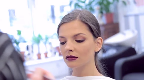 Make-up artist covers model's lips with lipstick Stock Footage 68749209