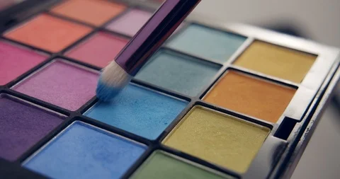Make-up artist dips a brush in blue palette Stock Footage 126352787