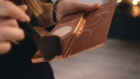 Make-up artist dips a large professional brush into a rouge and face oval Video stock 101030733